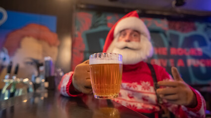 Santa Claus drinking beer at a bar. 