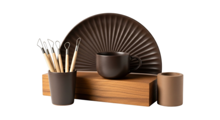 A collection of dark ceramic and wooden objects including a fan shaped plate cup and brushes isolated on transparent background
