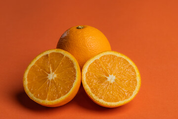 orange juicy oranges on an orange background.