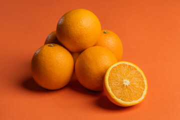 orange juicy oranges on an orange background.