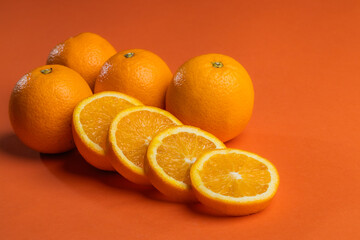 orange juicy oranges on an orange background.