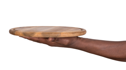 Hand holding a round wooden cutting board or a tray isolated on white or transparent background