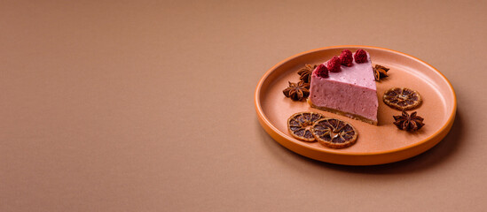 Raspberry or strawberry cheesecake, a slice of sweet red cake with berries. Raspberry cheesecake