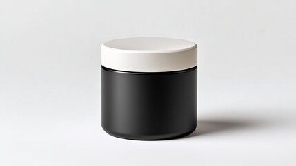 Photo of minimalist black cylindrical cosmetic jar with matte white lid on seamless white background