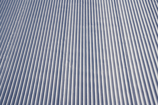Perfect groove ski slope snow pattern close-up view, winter concept
