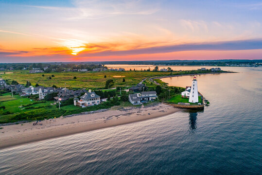 Lynde Point Lighthouse (also known as the Inner Light) and its adjacent keeper's house are viewed from an aerial perspective during a summer sunset in Old Saybrook, Connecticut, New England.