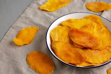 Organic Dried Mangos on a Plate, side view.