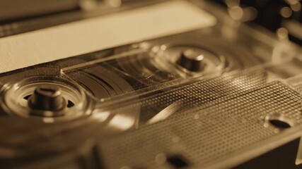 Vintage audio cassette tape with magnetic ribbon and spools in sepia tone