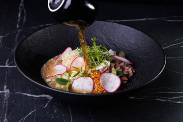 Soup Bowl With Radish, Beef, Eggs, Greens, And Delicate Golden Broth Pour