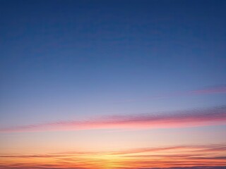 Obraz premium Serene Sunset Sky: Vibrant Orange and Pink Clouds at Dusk - Peaceful Atmospheric Background for Design