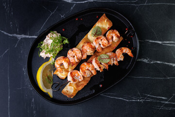 Gourmet Shrimp Skewers on Crispy Bread with Lemon Wedge and Fresh Green