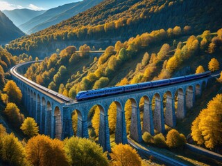 Scenic Autumn Train Ride: A Blue Express Crosses a Grand Arched Viaduct Amidst Golden Mountain Forests