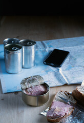 The essential roadside break - canned food supply the energy, while the phone and map are used to plot the next leg of the journey