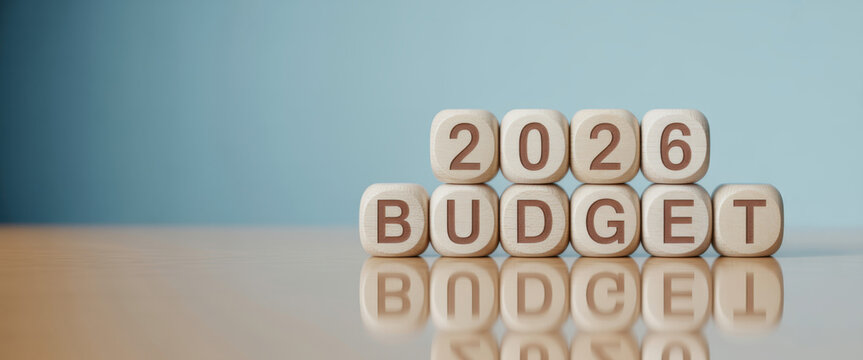 Wooden toy cubes forming the text "2026 BUDGET". Concept for planning the yearly budget for 2026.
