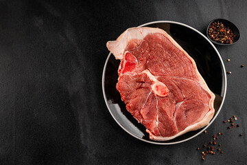 Bone-in ham steak, raw pork ham on the bone tasty snack fresh gourmet food background on the table  rustic food top view copy space