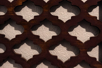 close-up of a decorative screen or grate with a repeating geometric pattern