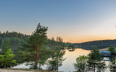 Fototapeta premium Serene lake with a boat floating on it