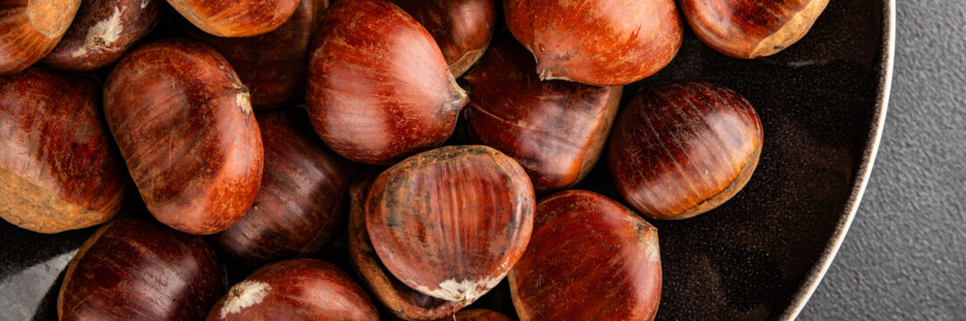 Edible chestnuts delicious treat tasty snack fresh gourmet food background on table rustic food top view copy space - Powered by Adobe