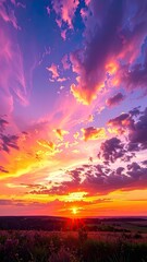 Vibrant sunset with dramatic purple and pink clouds over a rolling landscape