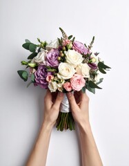 Hands holding a lush bouquet of purple, pink, and white roses with greenery