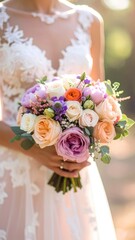 Bride in a lace gown holding a colorful floral bouquet in soft sunlight
