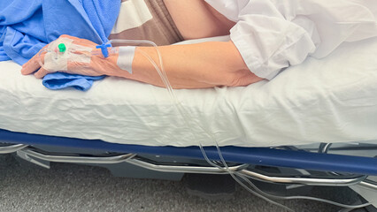 Patient Lying On Hospital Bed With Intravenous IV Line Attached To Hand During Medical Care Procedure In Modern Clinical Healthcare Setting Pro Photo