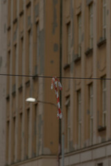 vertical plaster facade with solitary lamp, tight crop emphasizes texture, repeating windows, beige tones