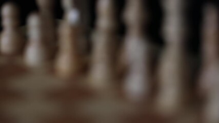 Chess, dynamic video of chess pieces on a rotating chessboard, the concept of confrontation between black and white. intellectual play, willingness to make the first move