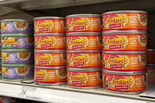Northville, Michigan, USA - Nov 9, 2025 : Stacked cans of Friskies prime filets chicken and tuna dinner wet cat food on a grocery shelf