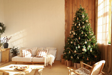 Cozy living room decorated for the holiday season with a beautiful Christmas tree and warm touches