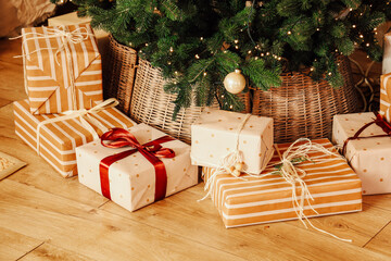 Beautifully wrapped gifts under a Christmas tree creating a festive atmosphere in a cozy home