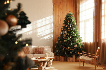 Cozy living room decorated for Christmas with a beautiful tree and warm sunlight streaming in