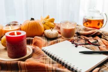 Autumn coziness with candles, pumpkins, and journaling