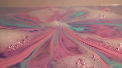Colorful bath bomb dissolving and creating swirls in water