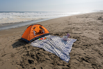 Young couple enjoying beach camping day vacation