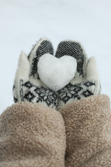 Knitted Mittens Holding a Snow Heart.. Winter Love and Cozy Seasonal Mood for Holidays and Cold Weather Themes