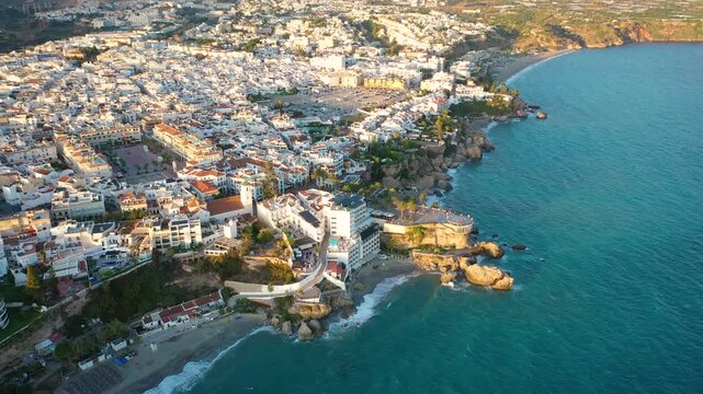 Aerial 4K video from drone to Balcony of Europe in Nerja resort town on Costa del Sol Mediterranean sea coast at sunsetin Andalusia, Spain. 