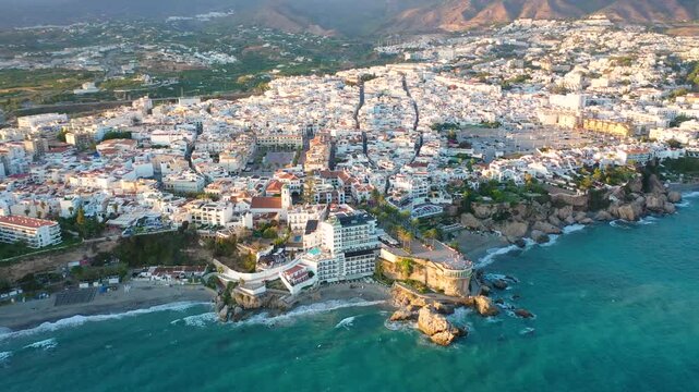 Aerial 4K video from drone to Balcony of Europe in Nerja resort town on Costa del Sol Mediterranean sea coast at sunsetin Andalusia, Spain. 