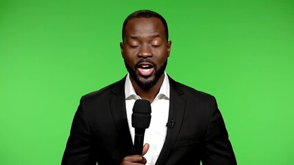 African American man speaking. Journalist with microphone. Black businessman talking. Person on green screen background. News anchor. TV host. Media personality. Professional speaker. Microphone in - Powered by Adobe