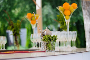 Outdoor bar with fresh mint, bar tools and citrus centerpieces ready for cocktails