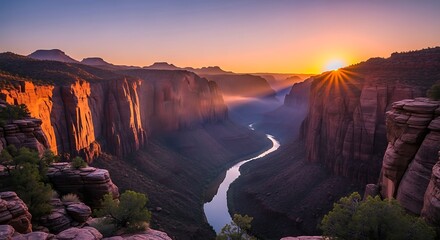 Dramatic sunrise casts golden light across canyon landscape and winding river