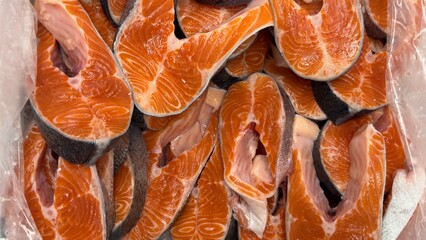 Vibrant Seafood Market: Diverse Selection of Fresh and Frozen Salmon Fish Slices Displayed in Icy Bins. Perfect for Showcasing Quality, Variety, and Culinary Delights in a Dynamic Retail Environment