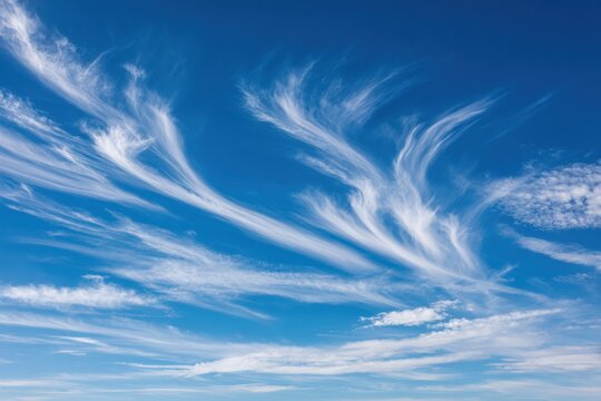 Clear blue sky with wispy clouds stretching across the horizon, evoking tranquility and freedom