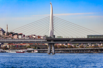 Golden Horn Metro Bridge with historic mosque and Istanbul cityscape, Turkey