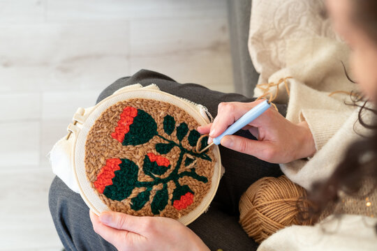 Creative embroidery session in a cozy indoor space with floral design being crafted on fabric - Powered by Adobe