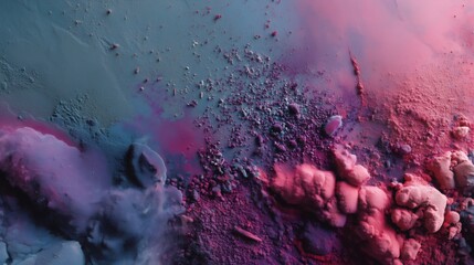 Colorful powder pigments are creating an abstract design on a gray background, mixing and blending to form a vibrant and textured composition