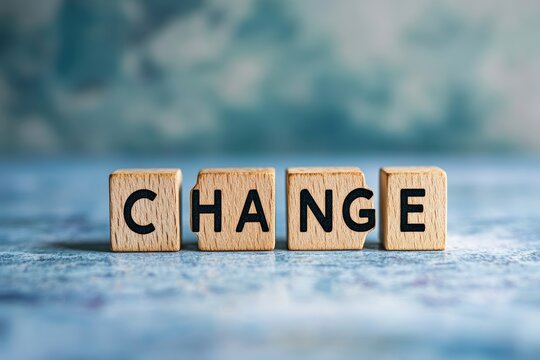 Wooden blocks spelling change on blue background