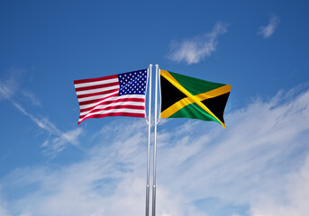 flags of jamaica and United States of America over blue sky background.