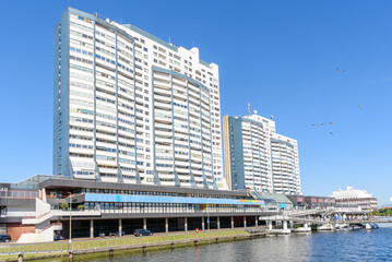 Large waterfront apartment buildings under clear blue sky in summer