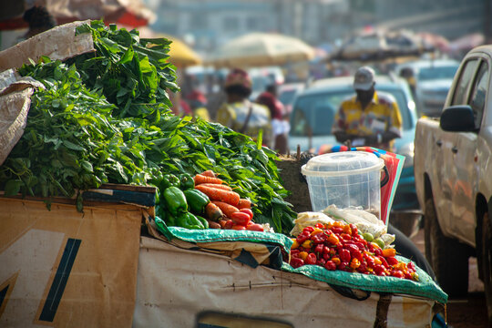 fresh vegetables at the market, Colorful photo of an African market in Cameroon, showcasing fresh vegetables cassava leaves, peppers, carrots and chilies.